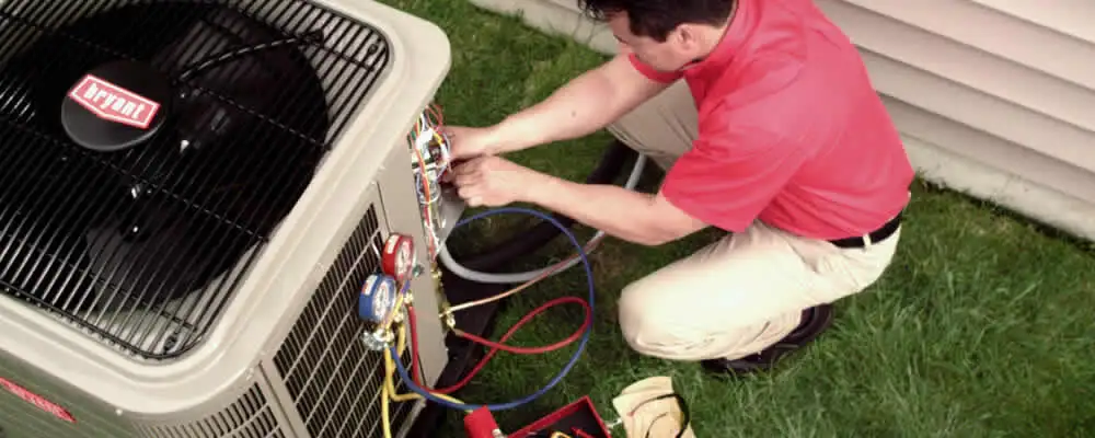 HVAC technician servicing an outdoor air conditioner unit in Detroit, MI