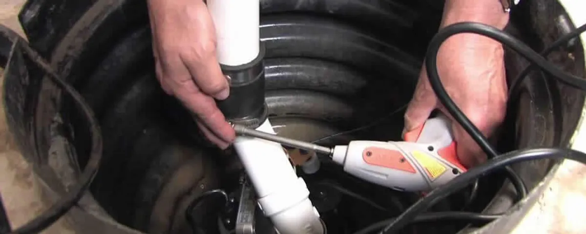 Sump pump installation technician connecting PVC discharge piping in Detroit, MI
